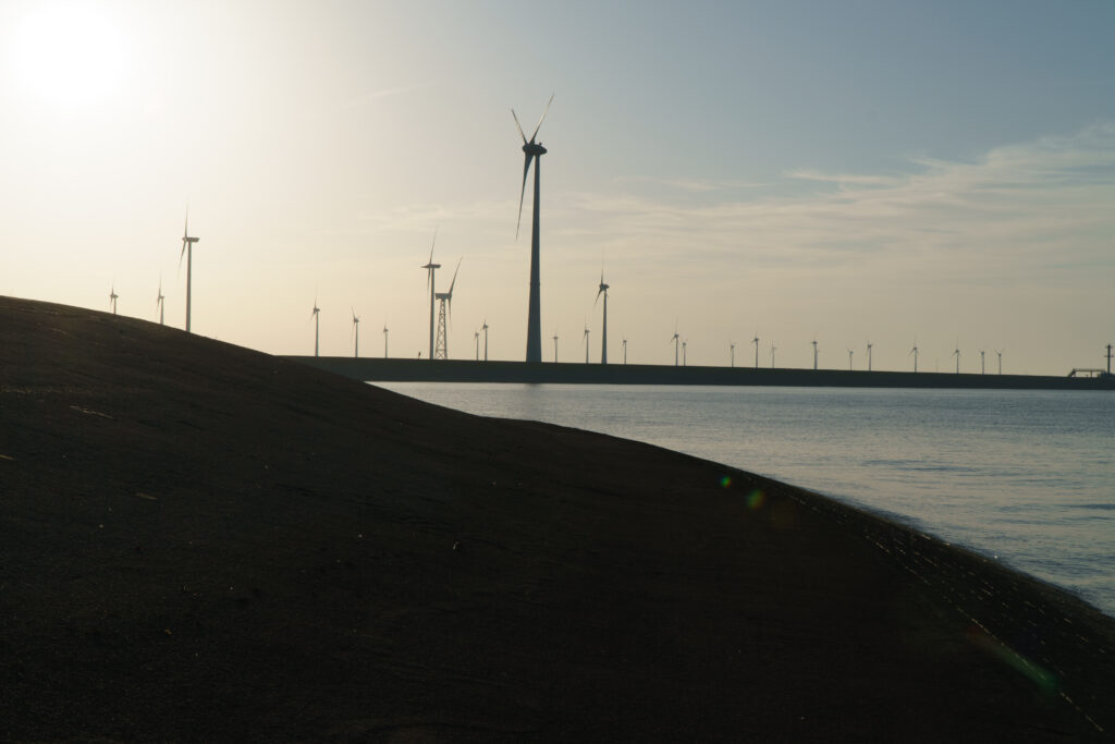 Field of modern windmills against a clear blue sky